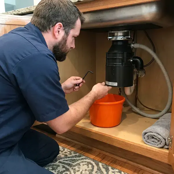 CKN Plumbing technician providing garbage disposal repair in Anchorage, AK